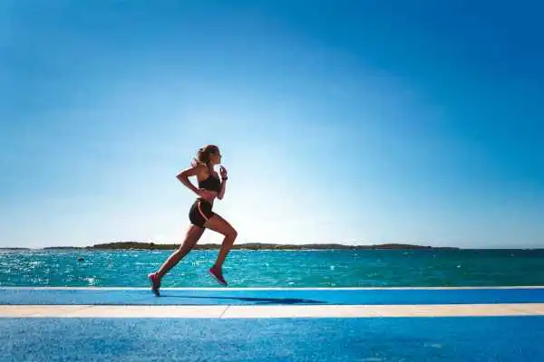 Woman running showing strong leg muscle Biggleswade